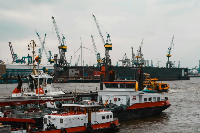 a large boat in the water next to other boats